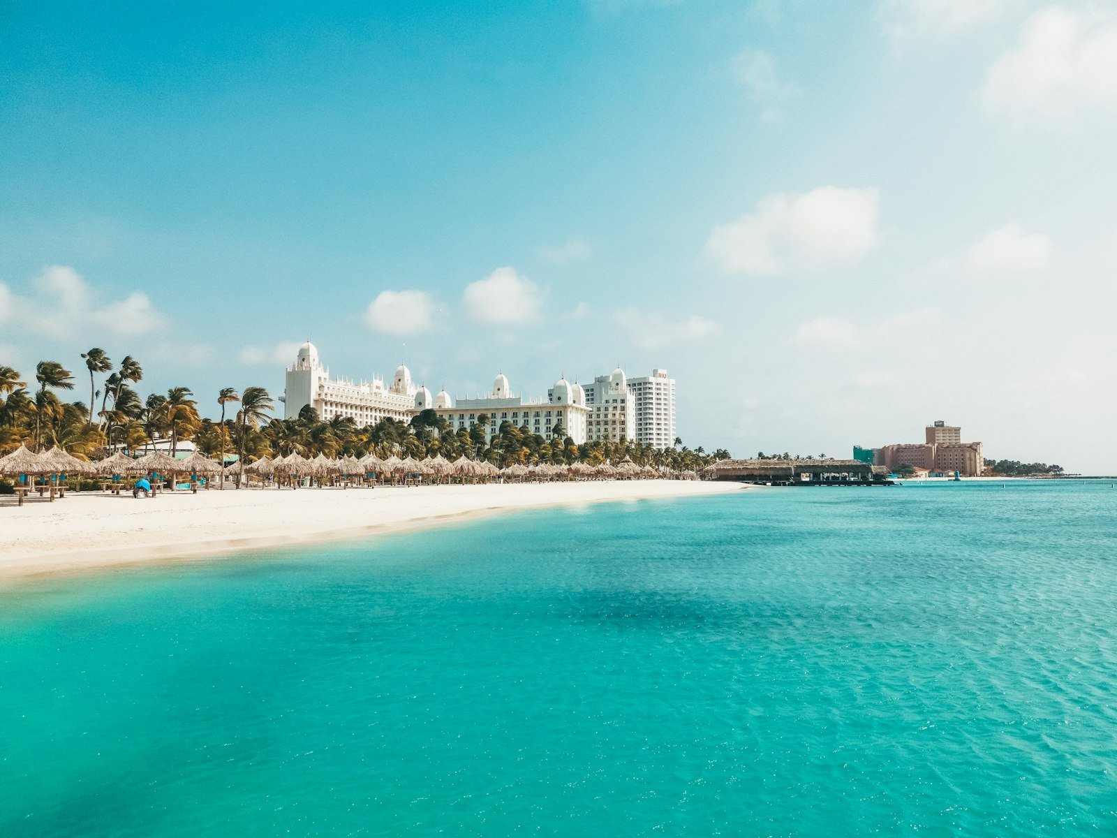 A view of a beach with a hotel in the background, Palm Beach, Aruba