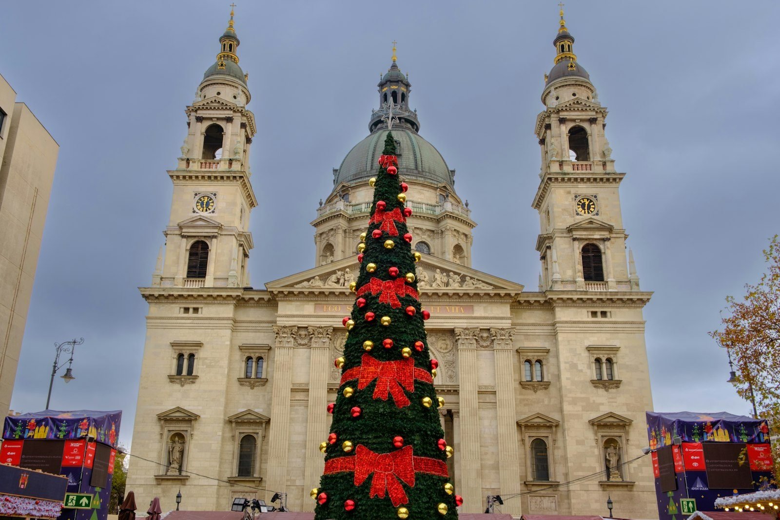 A large Christmas tree in front of a church in Budapest