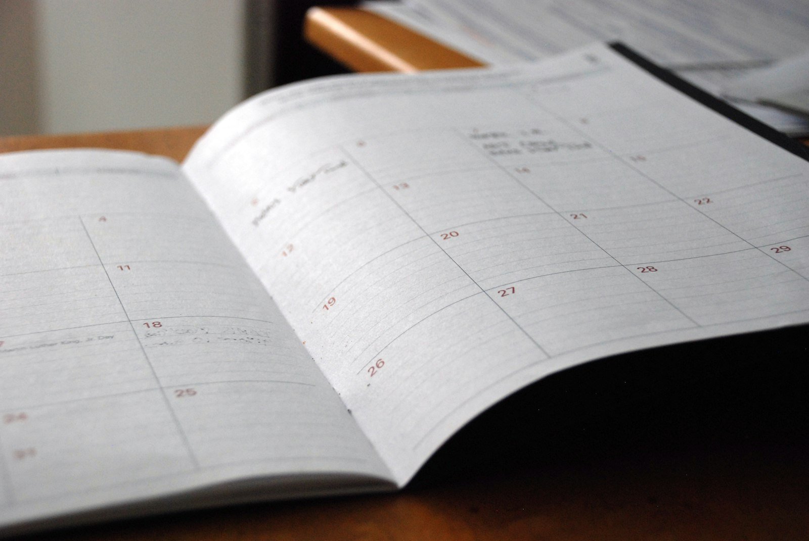 Open monthly planner on wooden desk