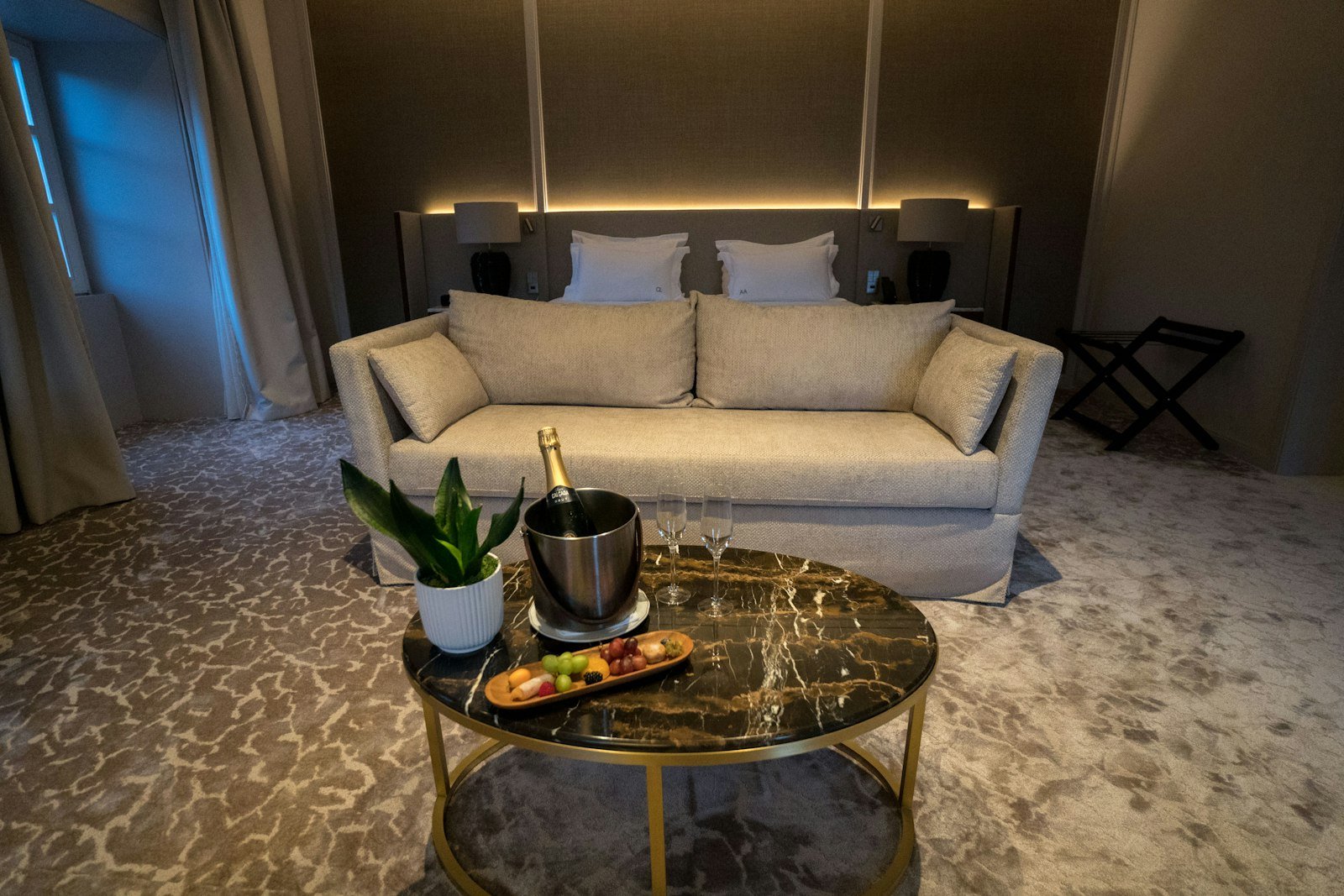 Luxurious hotel suite with champagne and snacks
