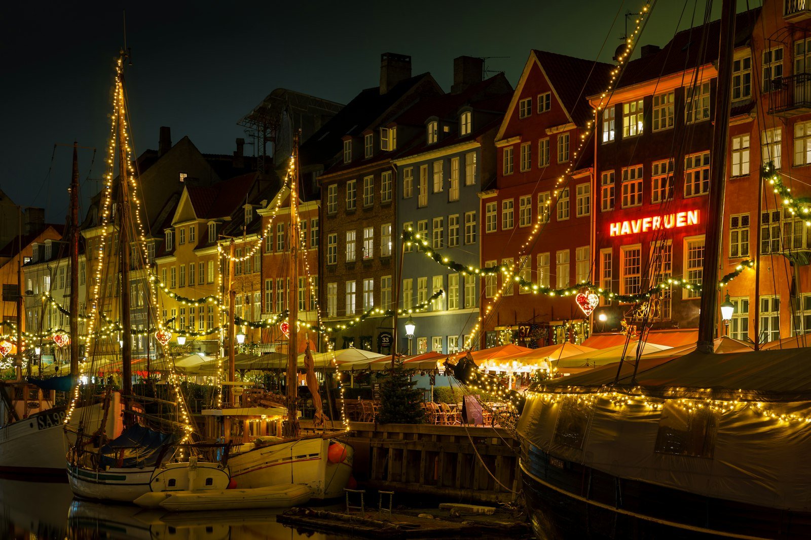 Boats along the Nyhavn canal at night, Copenhagen, Denmark