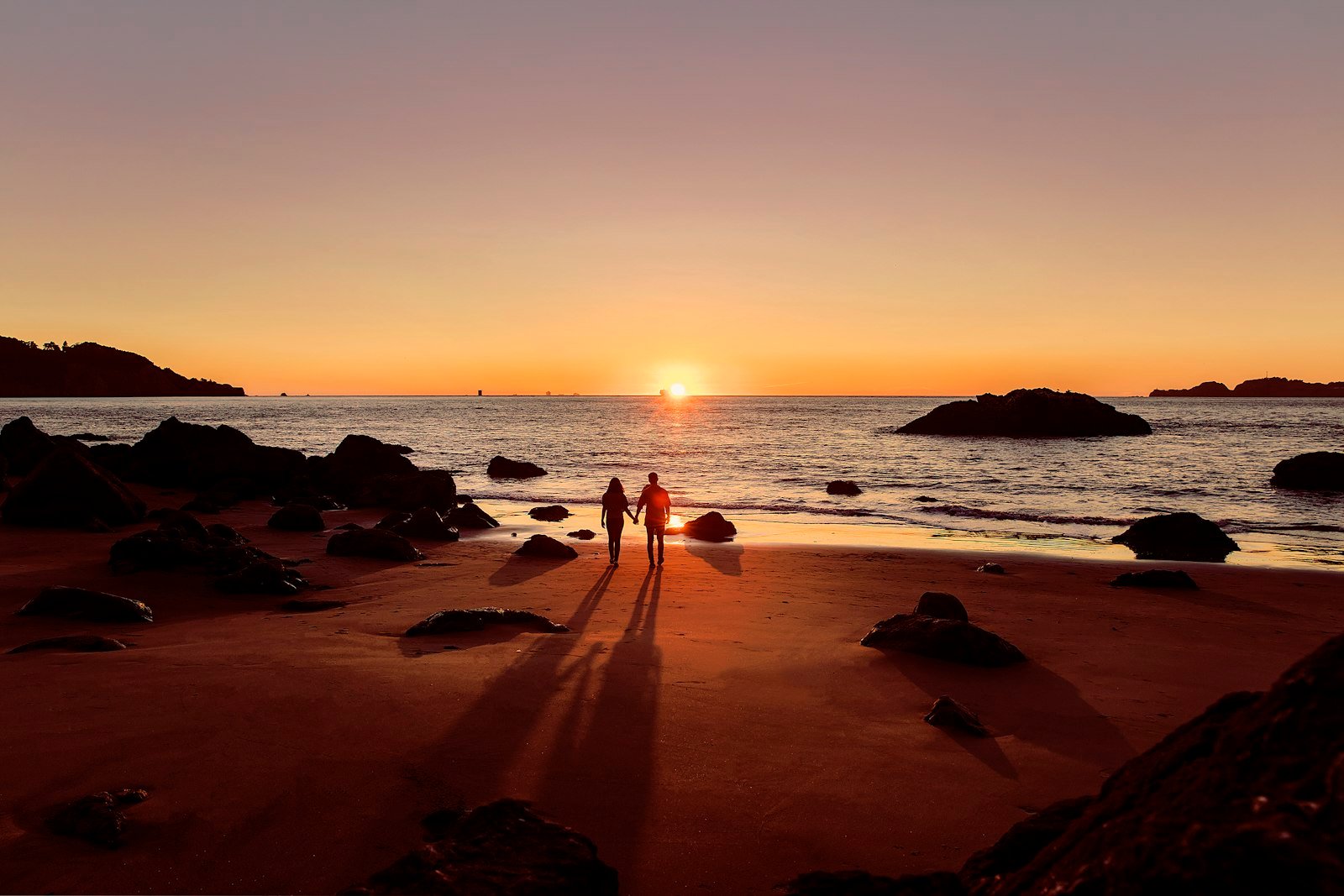 Man in black shorts walking on beach during sunset, Baker Beach, San Francisco, CA, USA