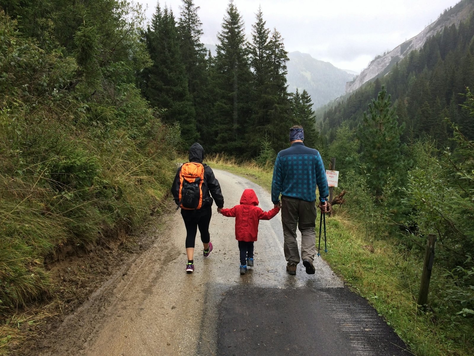 Man, woman, and child walking together along dirt road, Riedingtal Nature Park, Zederhaus, Austria