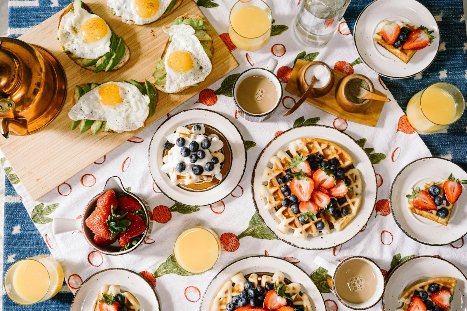 Breakfast spread with waffles eggs and juice, Tucson, United States