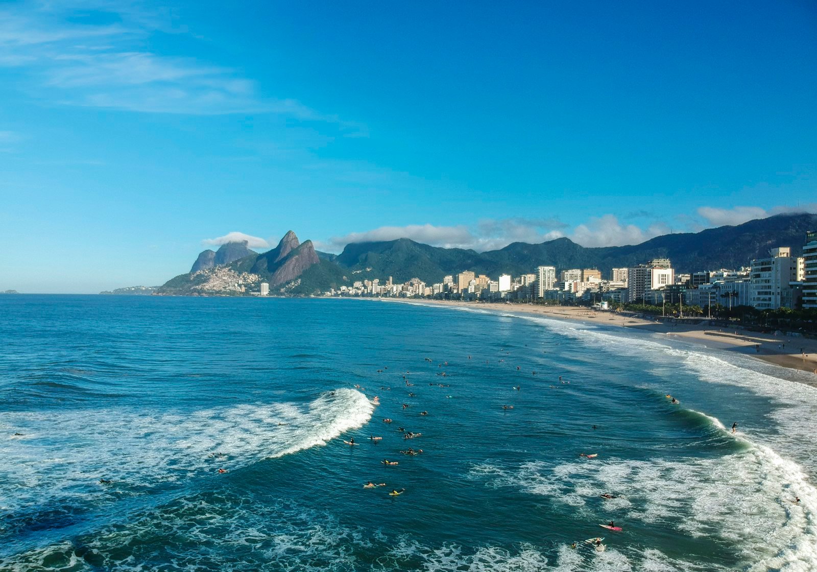Surfers and city buildings along Ipanema Beach, Rio de Janeiro