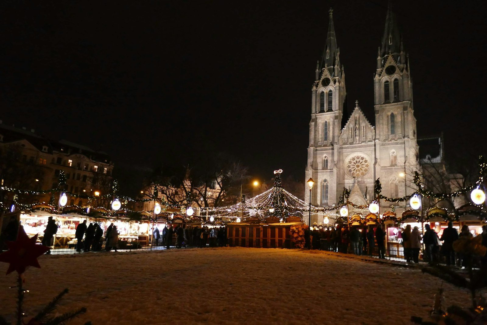Christmas market in front of a church at night, Prague, Czech Republic