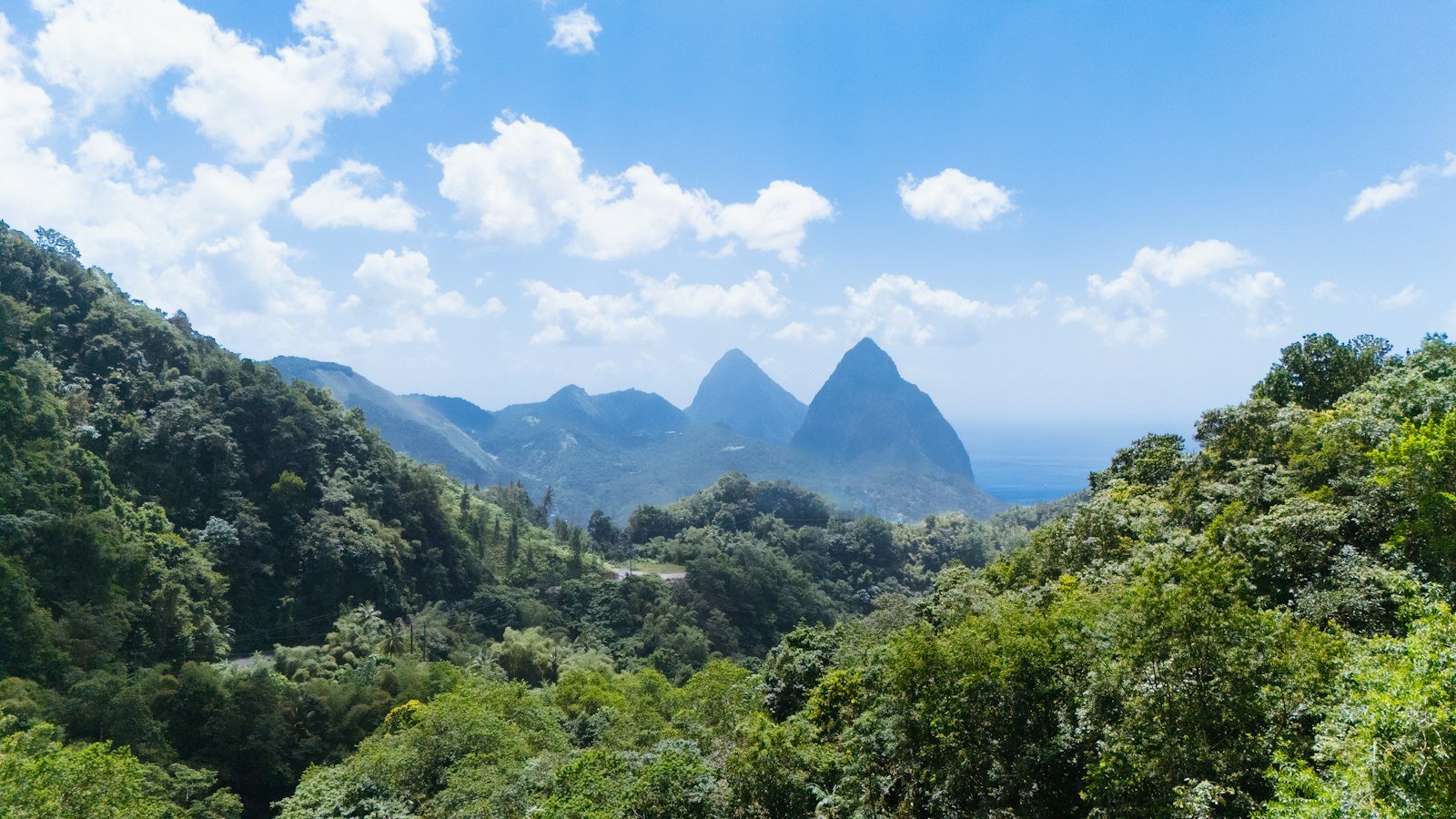 A view of a mountain range with trees and mountains in the background